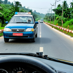 **

A public service announcement poster in Cameroon. The poster shows a concerned-looking driver wearing a seatbelt and attentively watching the road. In the background are common road hazards. The text is in Bengali and emphasizes the importance of safe driving habits and obeying traffic laws. "Safe for work", "appropriate content", "fully clothed", "family-friendly".

**